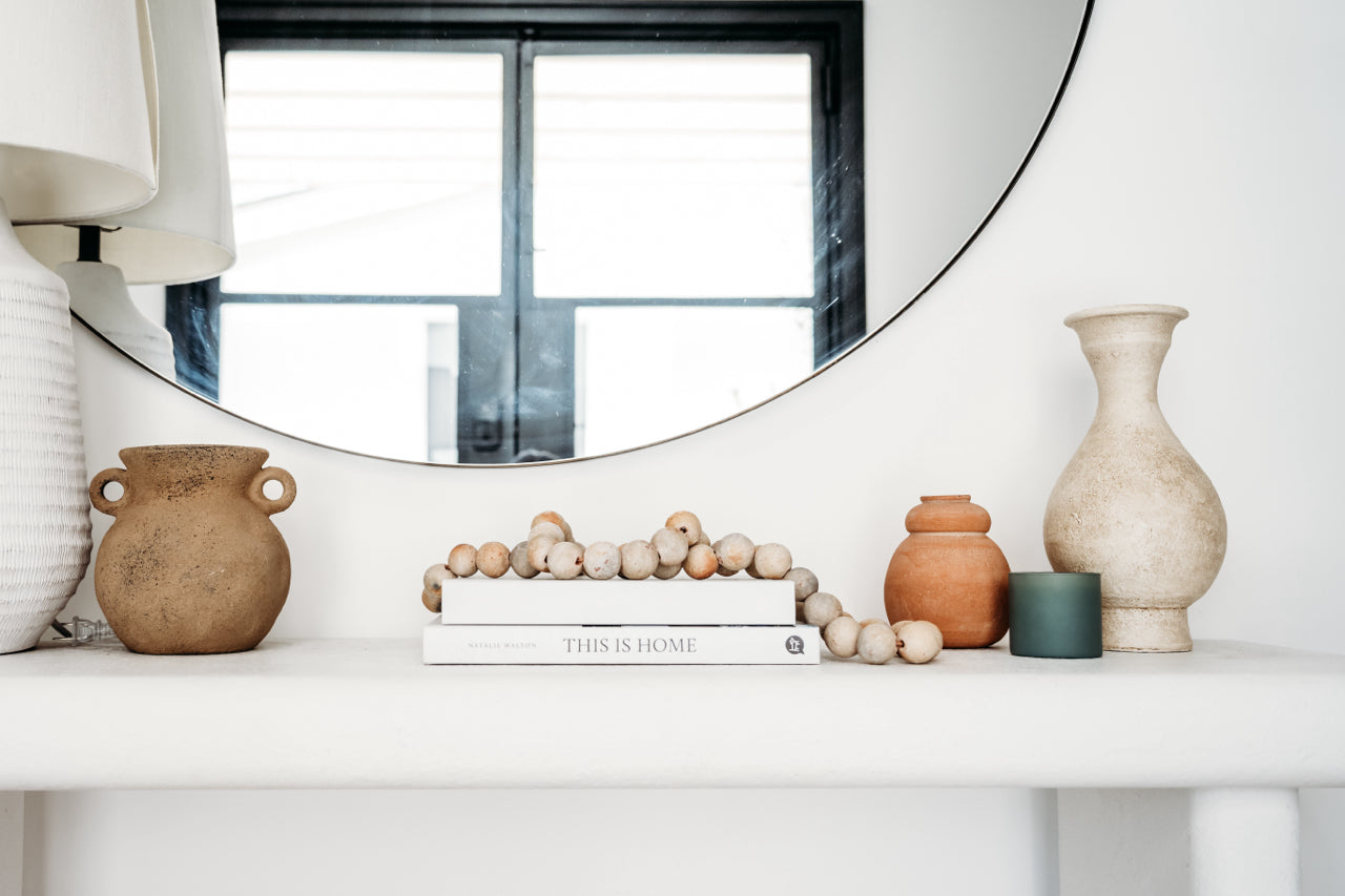 potted plants styled on a wood shelf