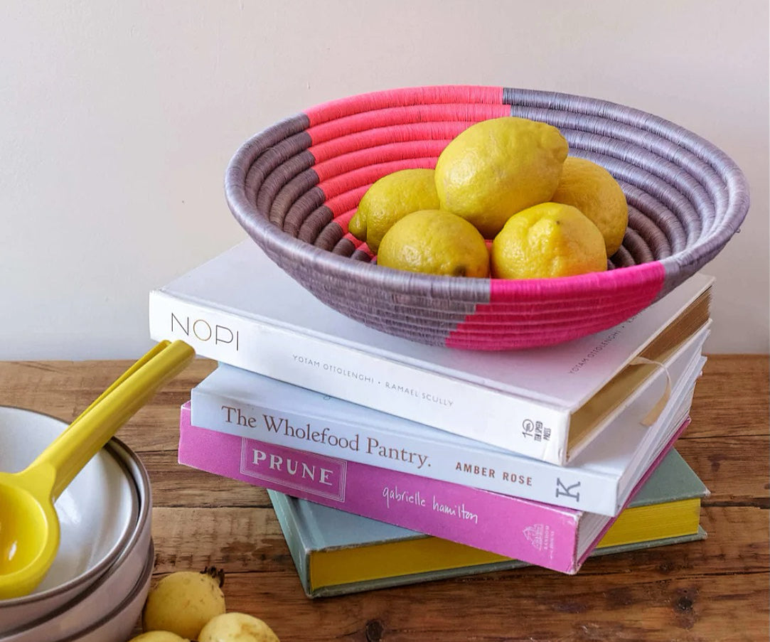 bright summer basket with fruit on cookbooks