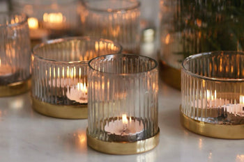 glowing candles in artisan made glass candle holders
