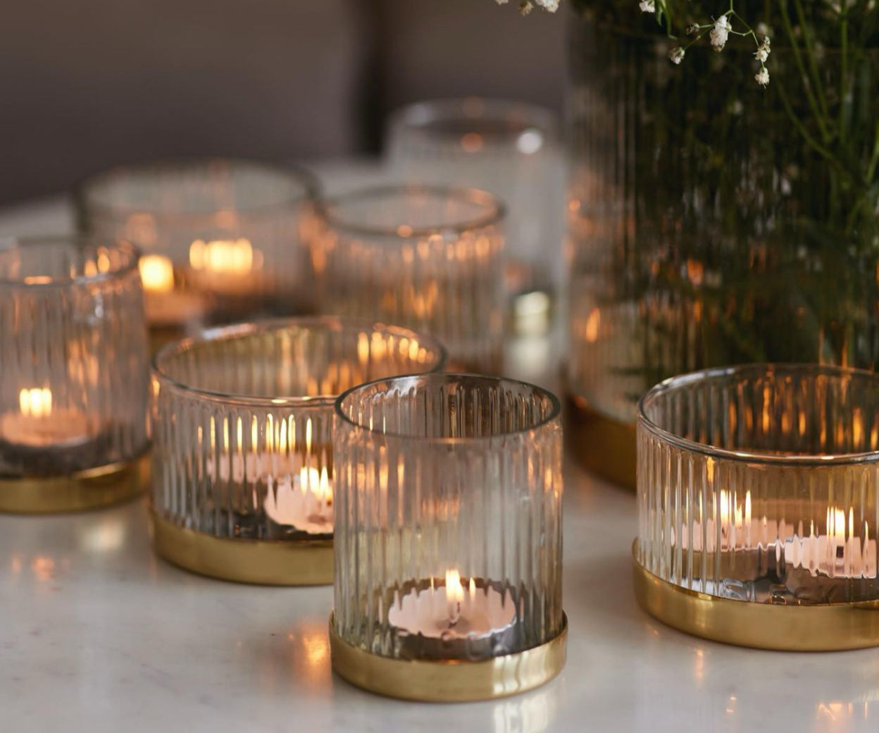 glowing candles in artisan made glass candle holders