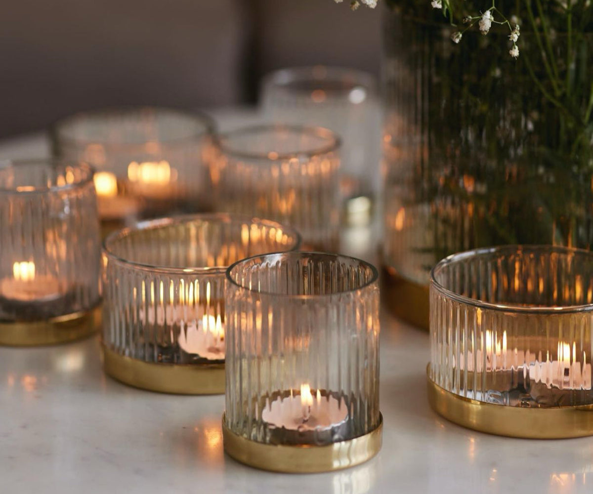glowing candles in artisan made glass candle holders